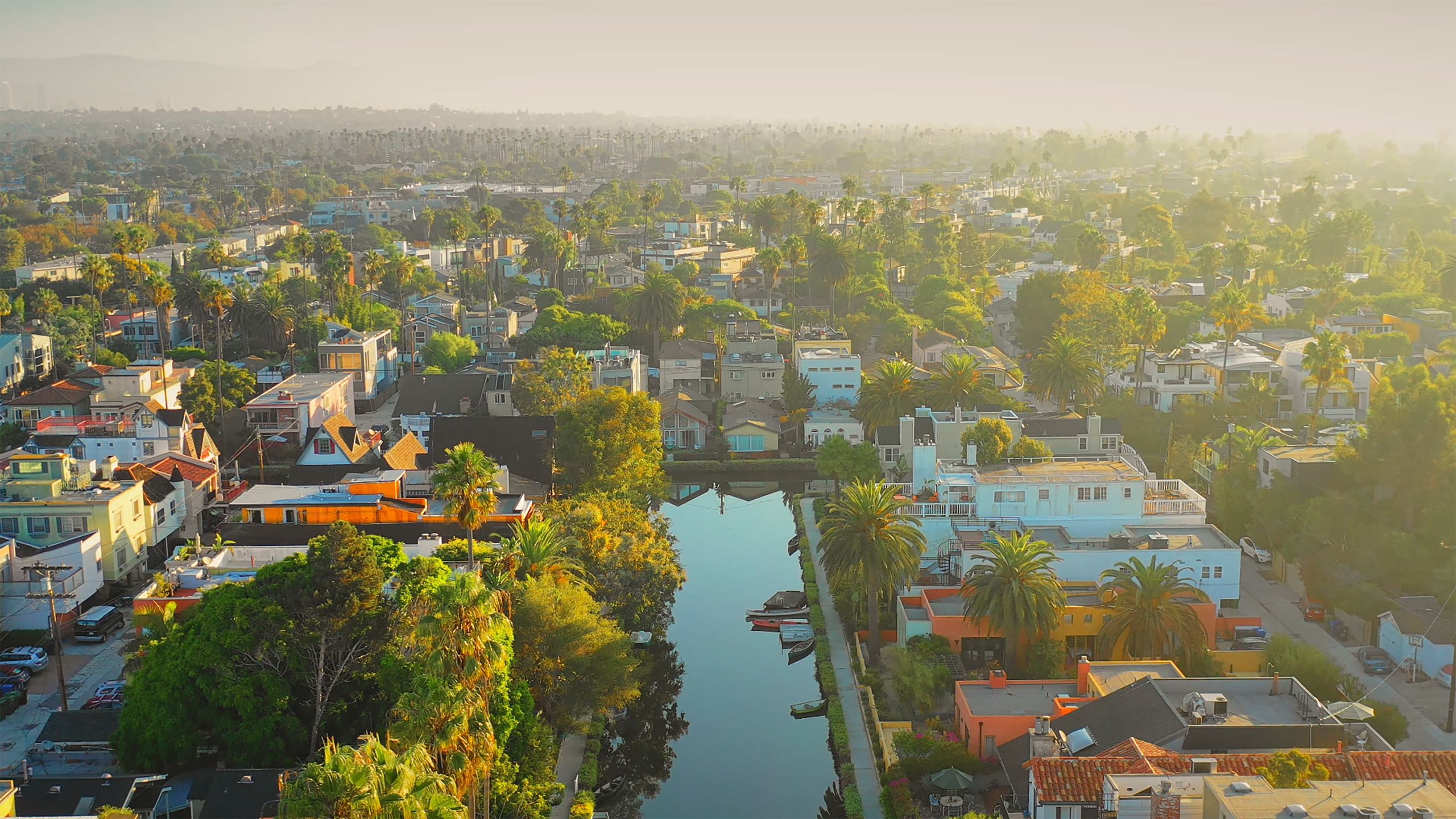 A scenic aerial view of a vibrant neighborhood with a canal running through it in Dĩ An, Vietnam.