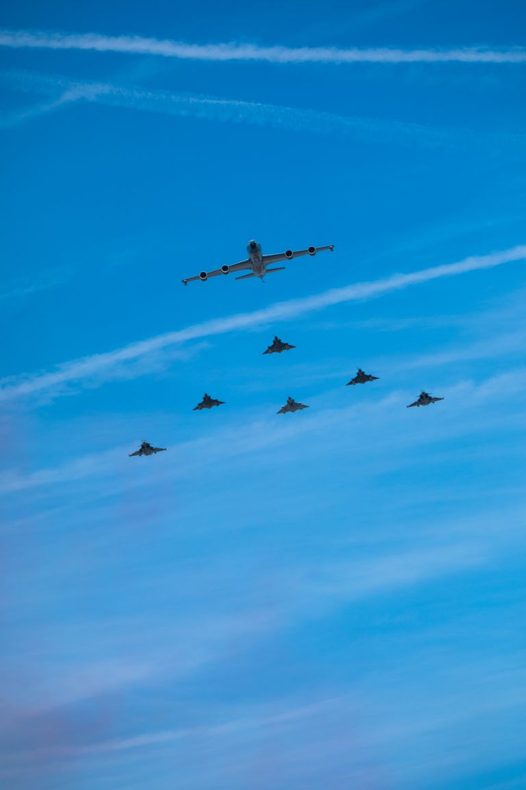 A striking display of fighter jets in formation against a clear blue sky, Paris air show.