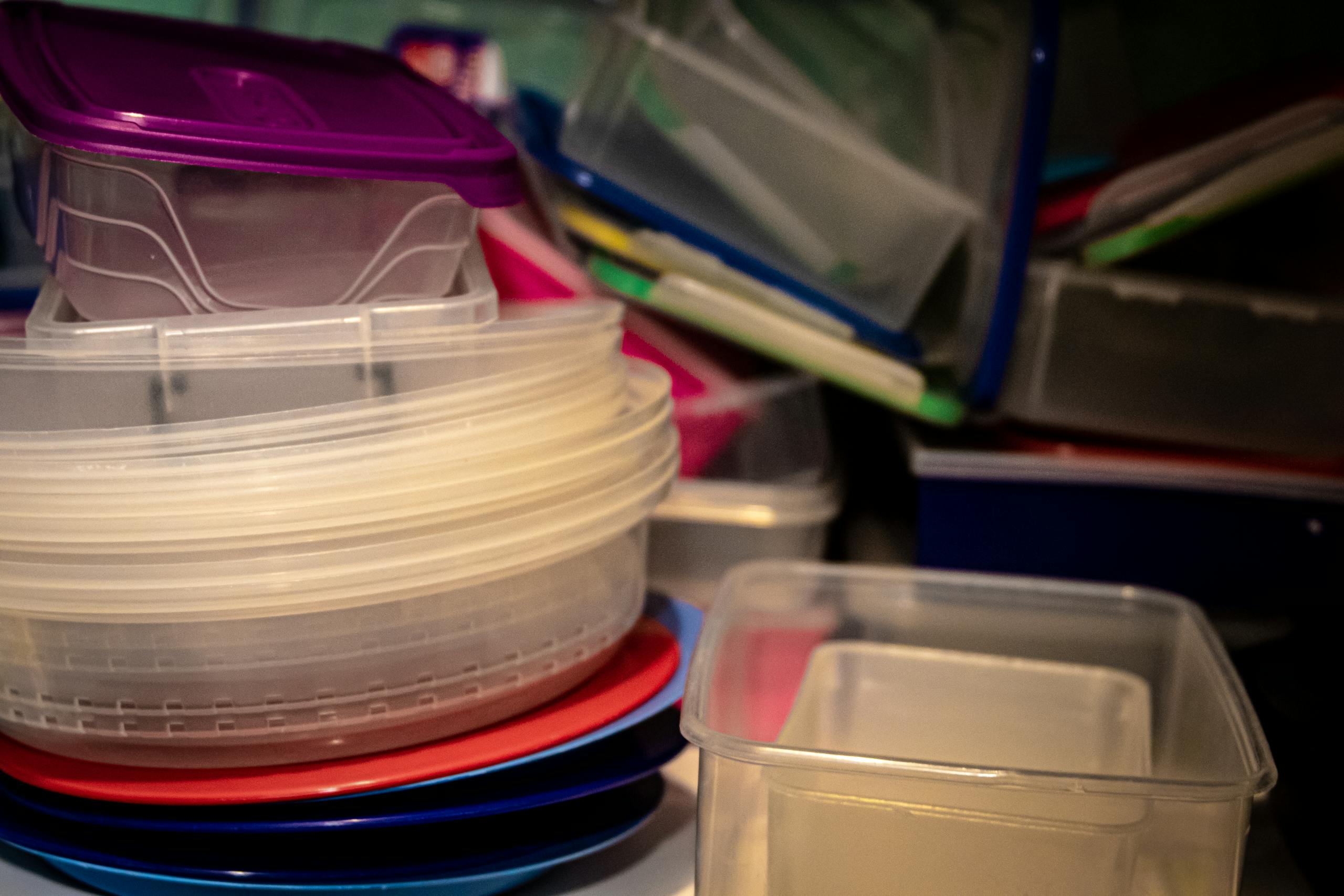 A variety of plastic storage containers stacked together, ideal for organizing kitchen spaces.