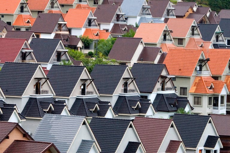 A vivid array of suburban rooftops showcasing diverse colors and architectural designs.