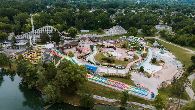 Aerial shot of an amusement park with water slides and roller coasters in Georgia.