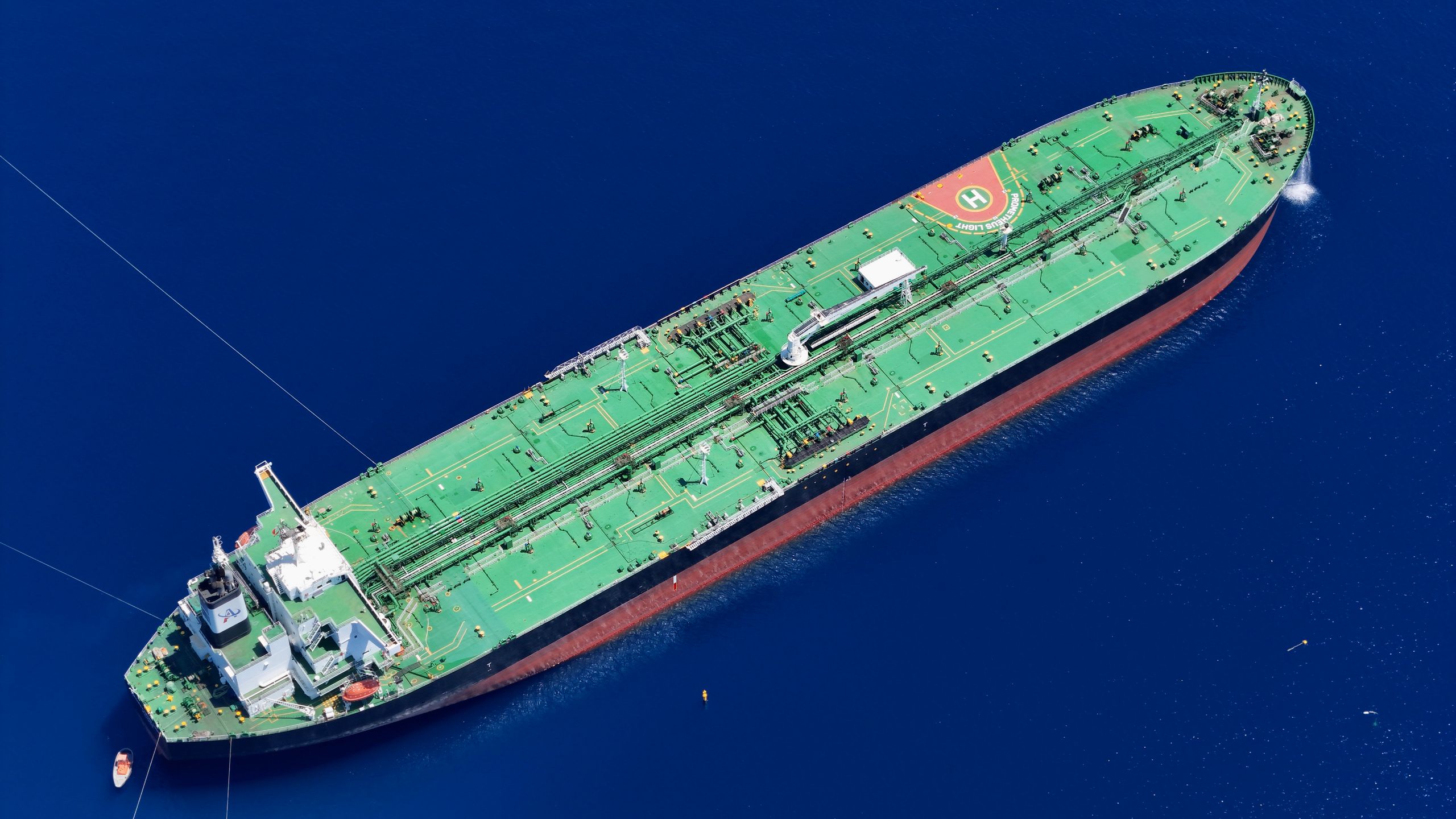 Aerial shot of an oil tanker sailing in the ocean near Vado Ligure, Italy.