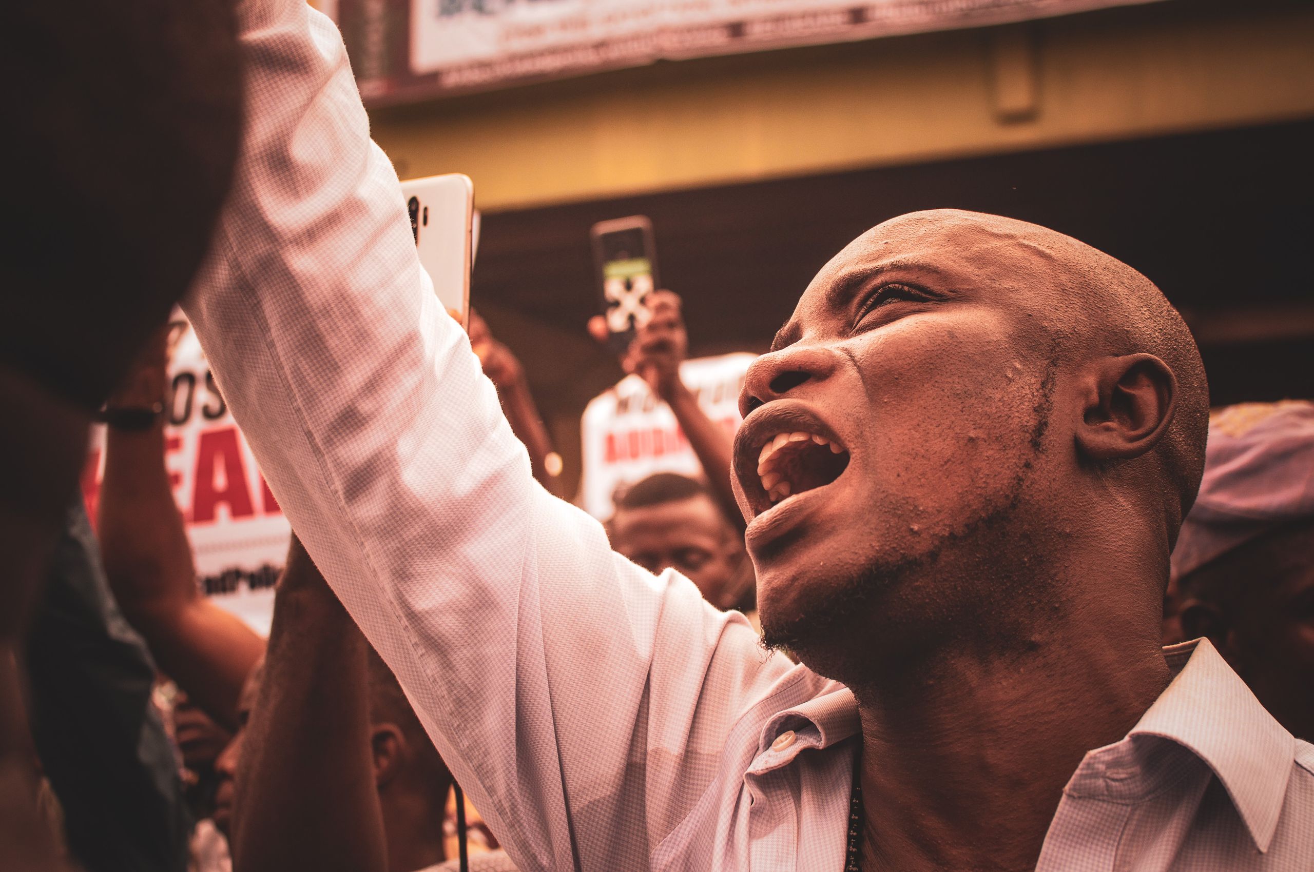 An engaged protestor shouting during a street demonstration, highlighting activism.