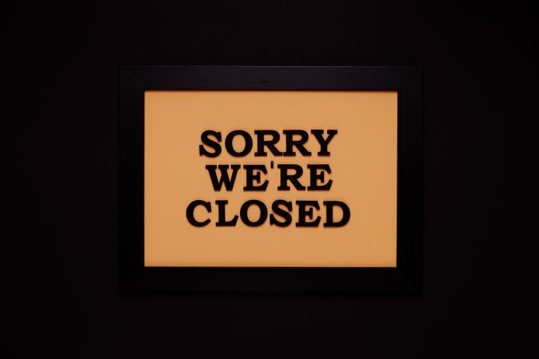 Black-framed 'Sorry We're Closed' sign against a dark backdrop, ideal for business themes.