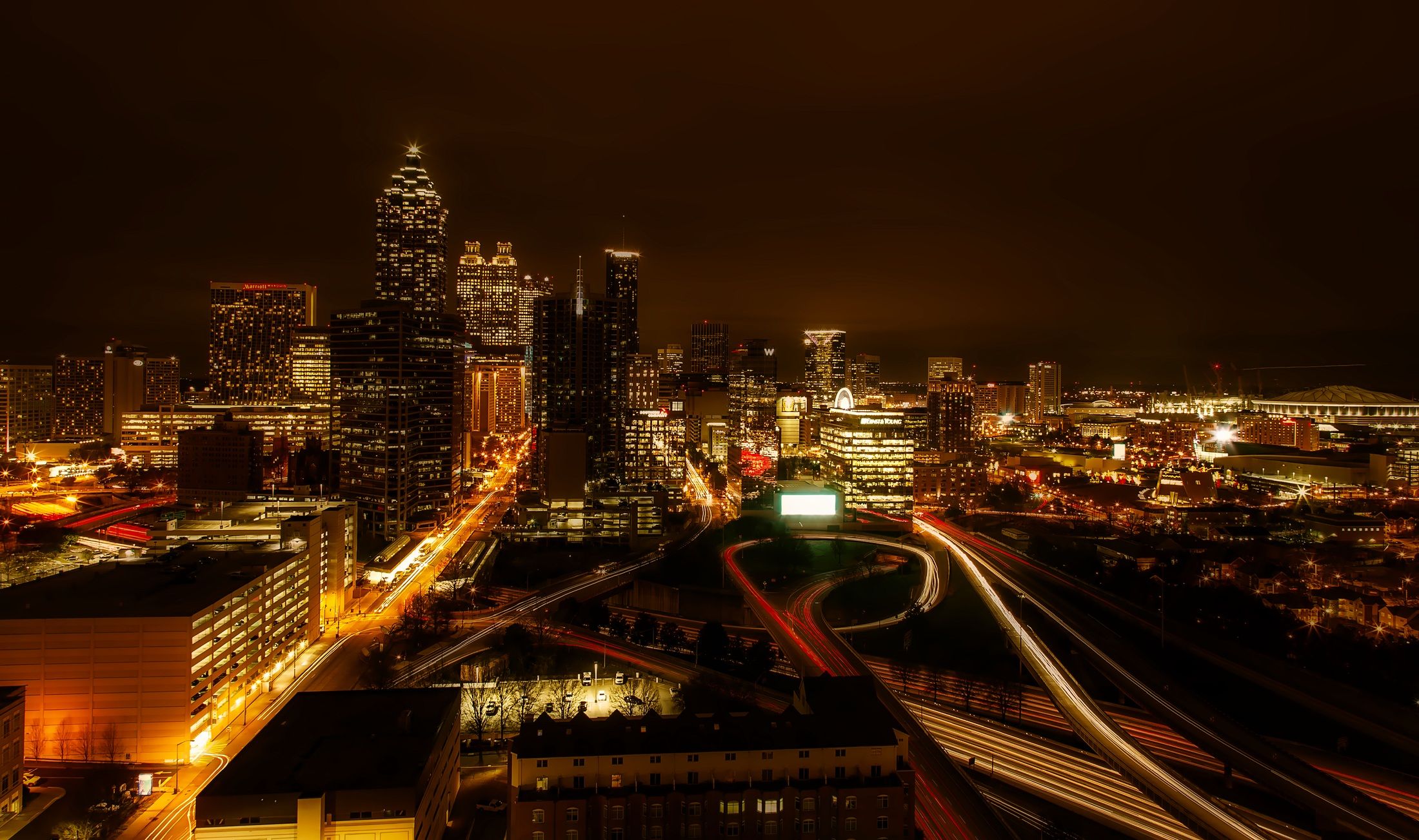 Captivating night view of Atlanta's skyline with glowing city lights and traffic trails.