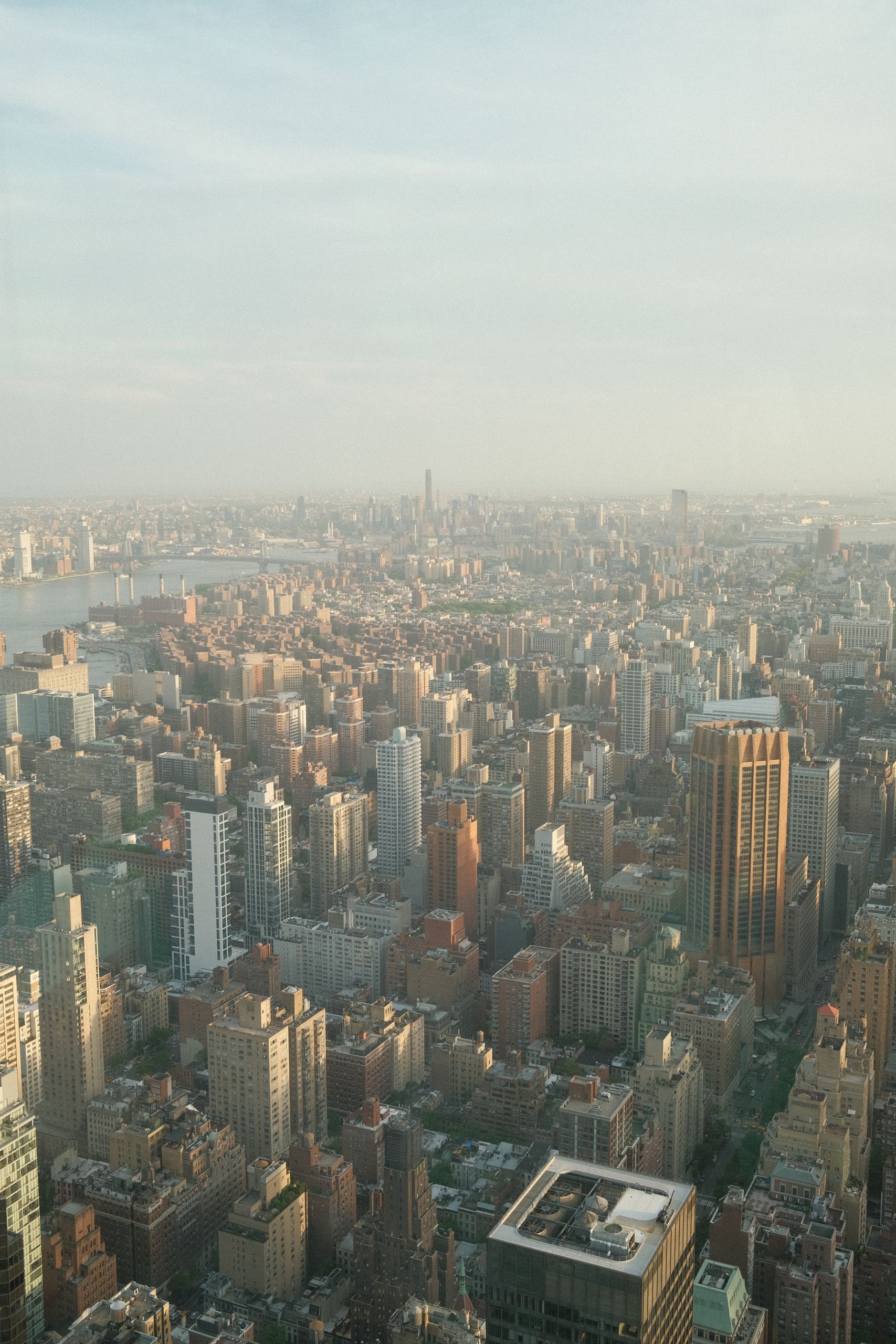 Capture the urban density of New York City with this stunning aerial view of skyscrapers at dusk.