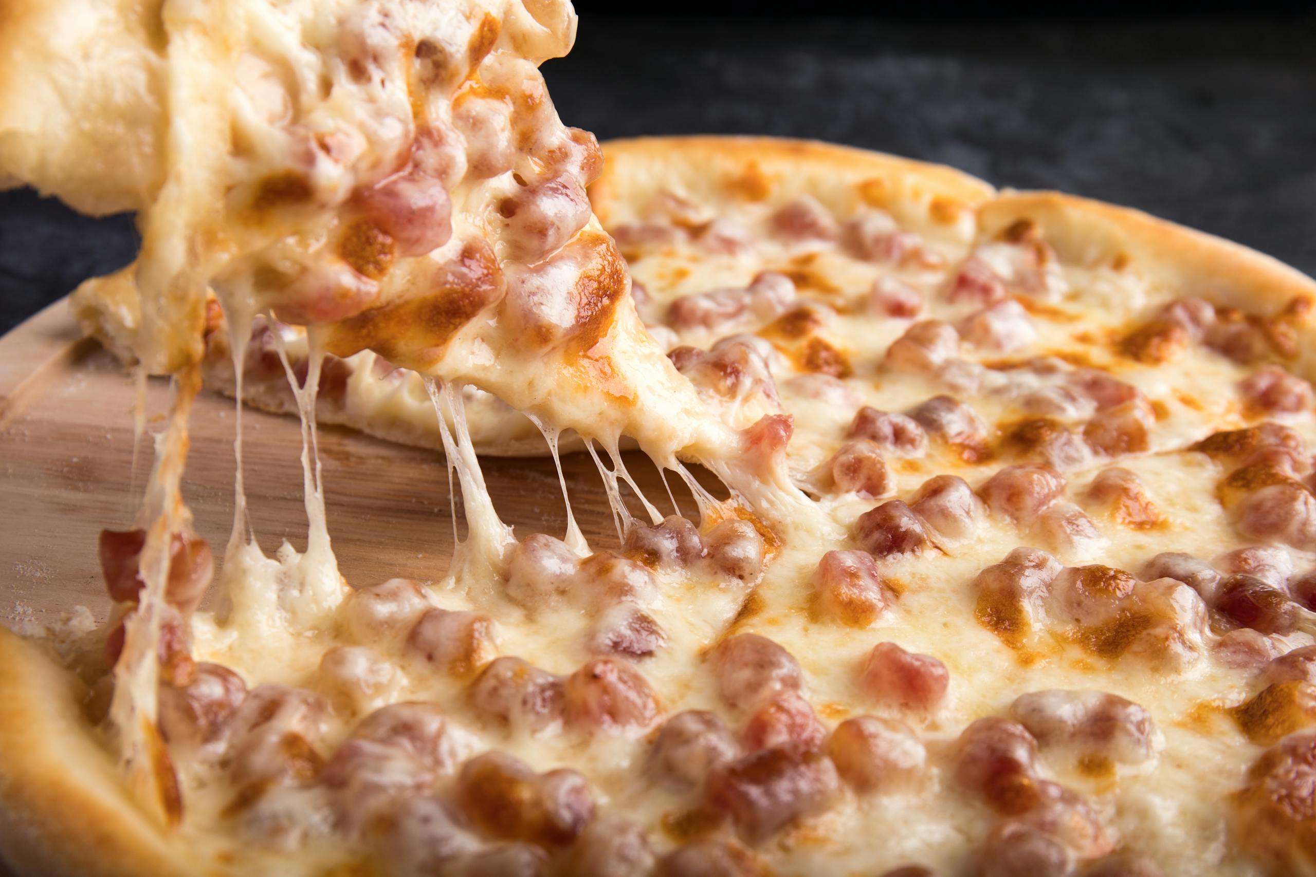 Close-up of a delicious pepperoni pizza slice with gooey mozzarella cheese.