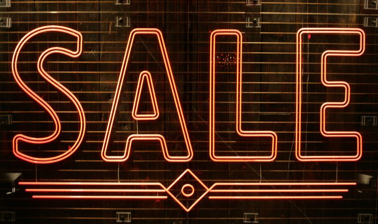 Close-up of a glowing neon SALE sign perfect for retail promotions.
