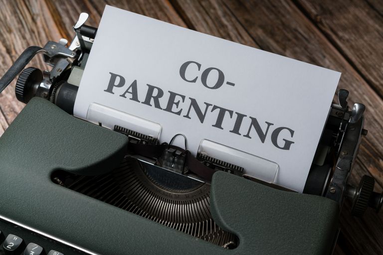 Close-up of a typewriter with a co-parenting document, symbolizing effective collaboration.
