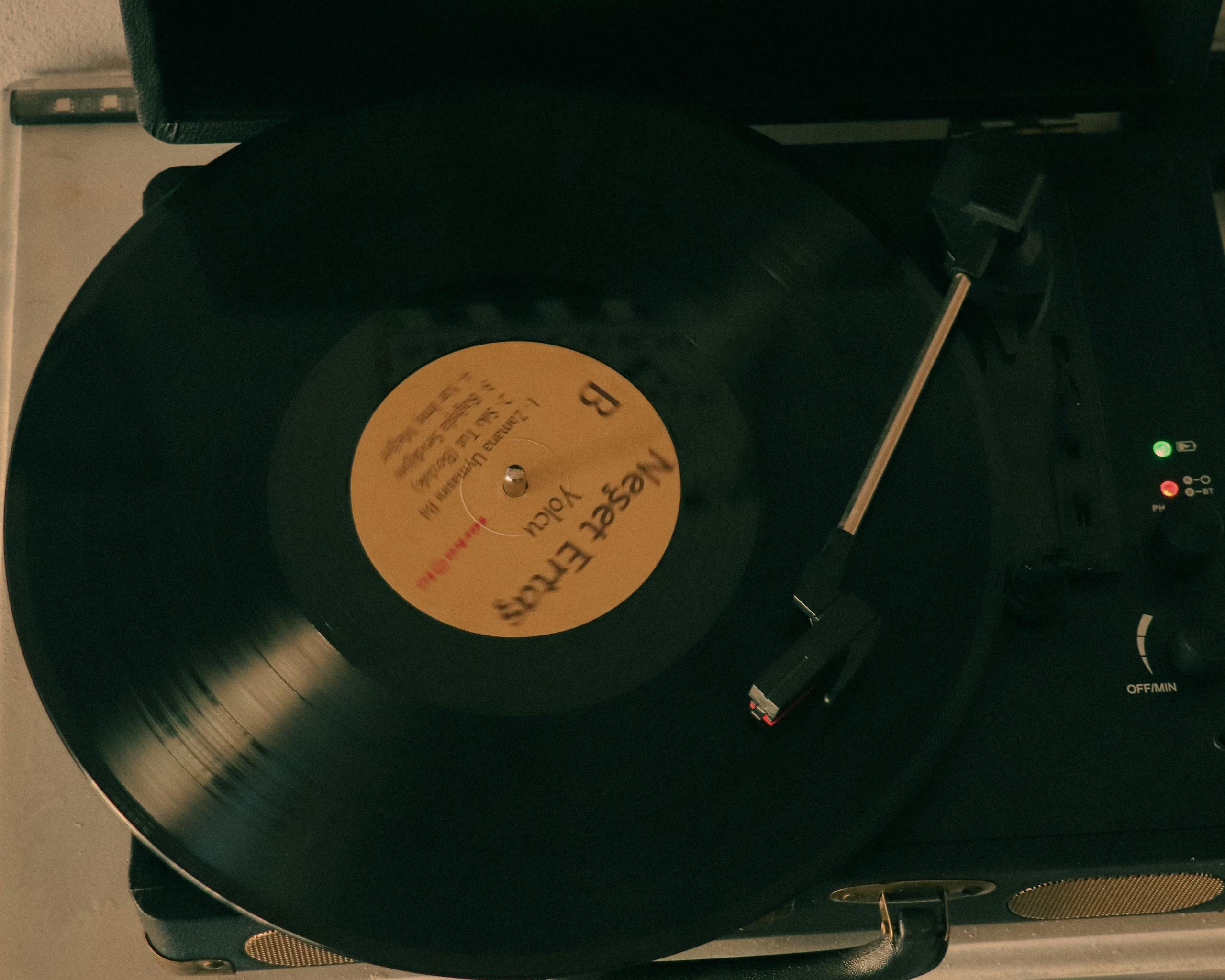 Close-up of a vinyl record spinning on a turntable, capturing the essence of vintage music.