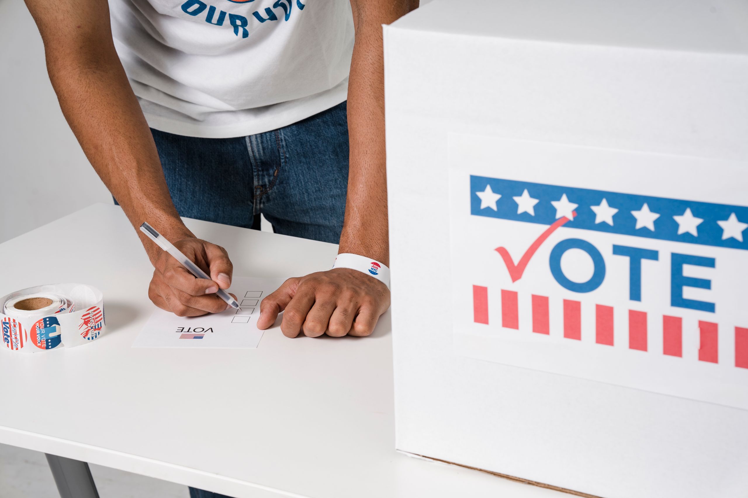 Close-up of man voting at ballot box, emphasizing democratic participation.