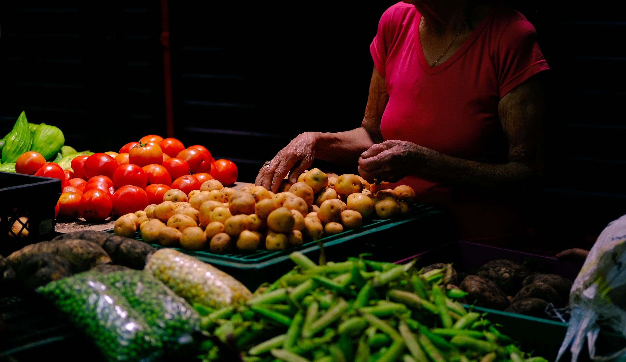 Colorful display of fresh vegetables at a market in Ibagu&eacute;, Colombia, showcasing local produce.