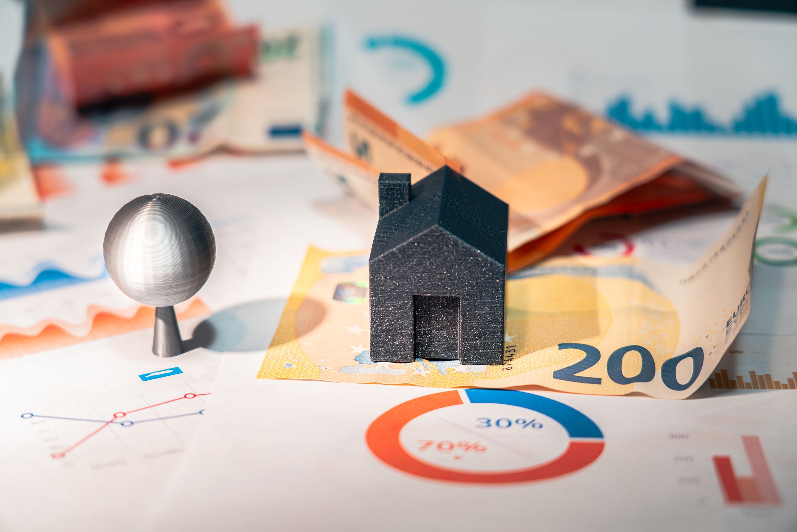 Conceptual image of real estate and finance involving euro currency and data charts, symbolizing investment.