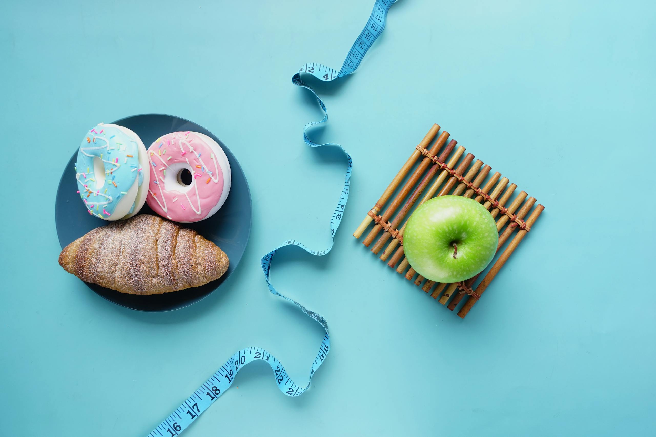 Contrast of healthy and indulgent foods with a measuring tape for weight management.
