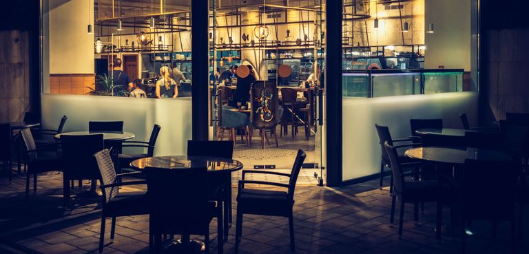 Cozy outdoor dining area at night in Sochi, featuring modern design and warm lighting.
