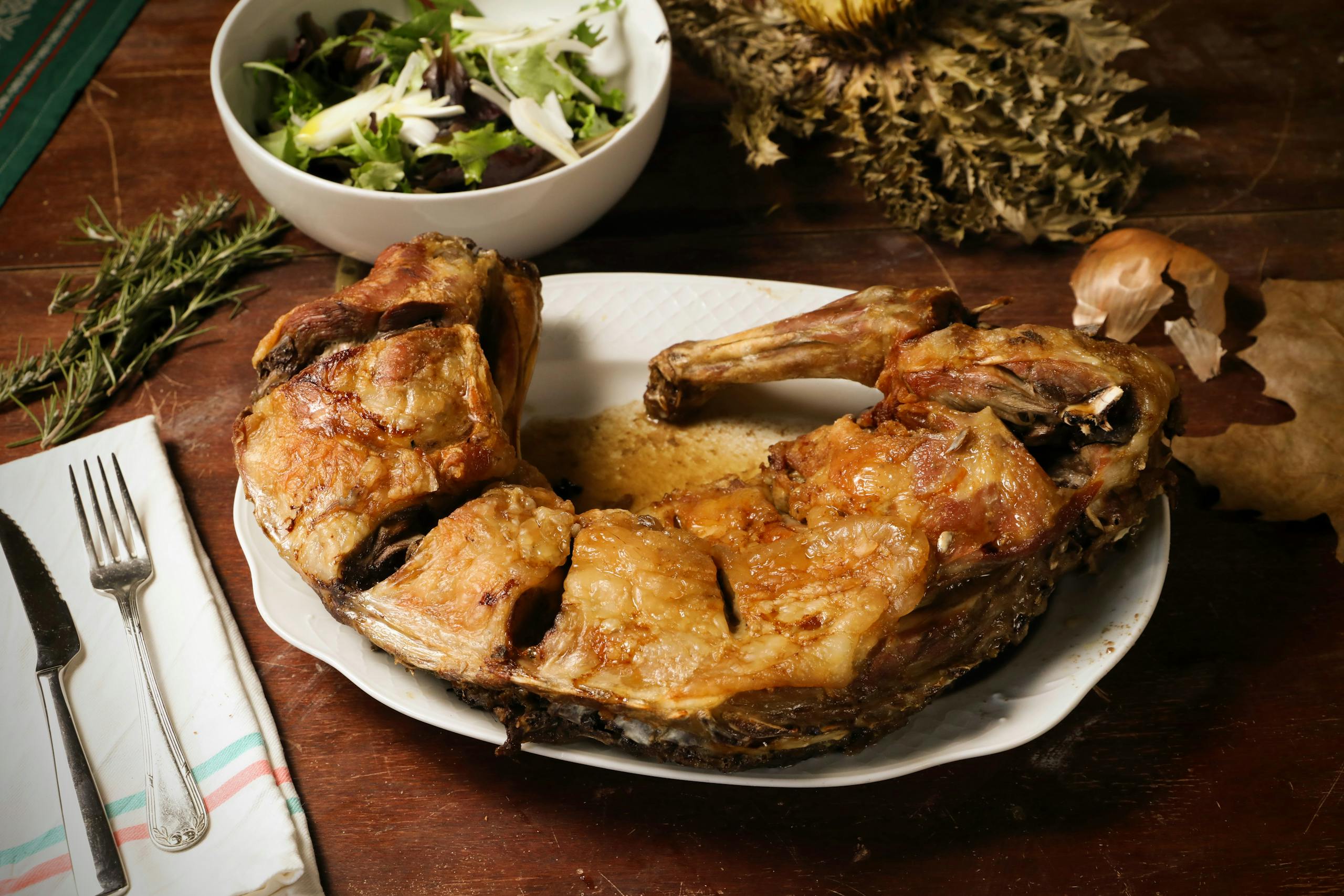 Delicious roast lamb served with fresh salad, perfect for a hearty meal.