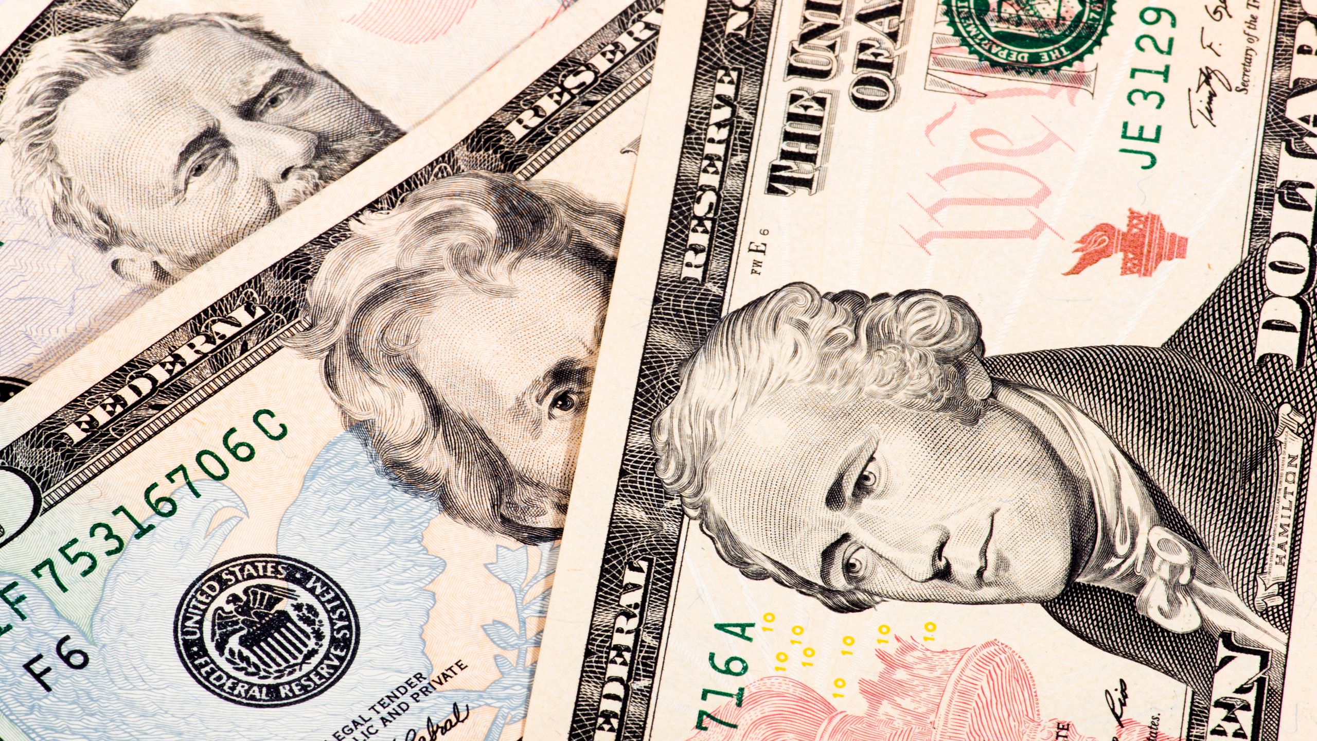 Detailed close-up shot of US dollar bills showing various denominations.
