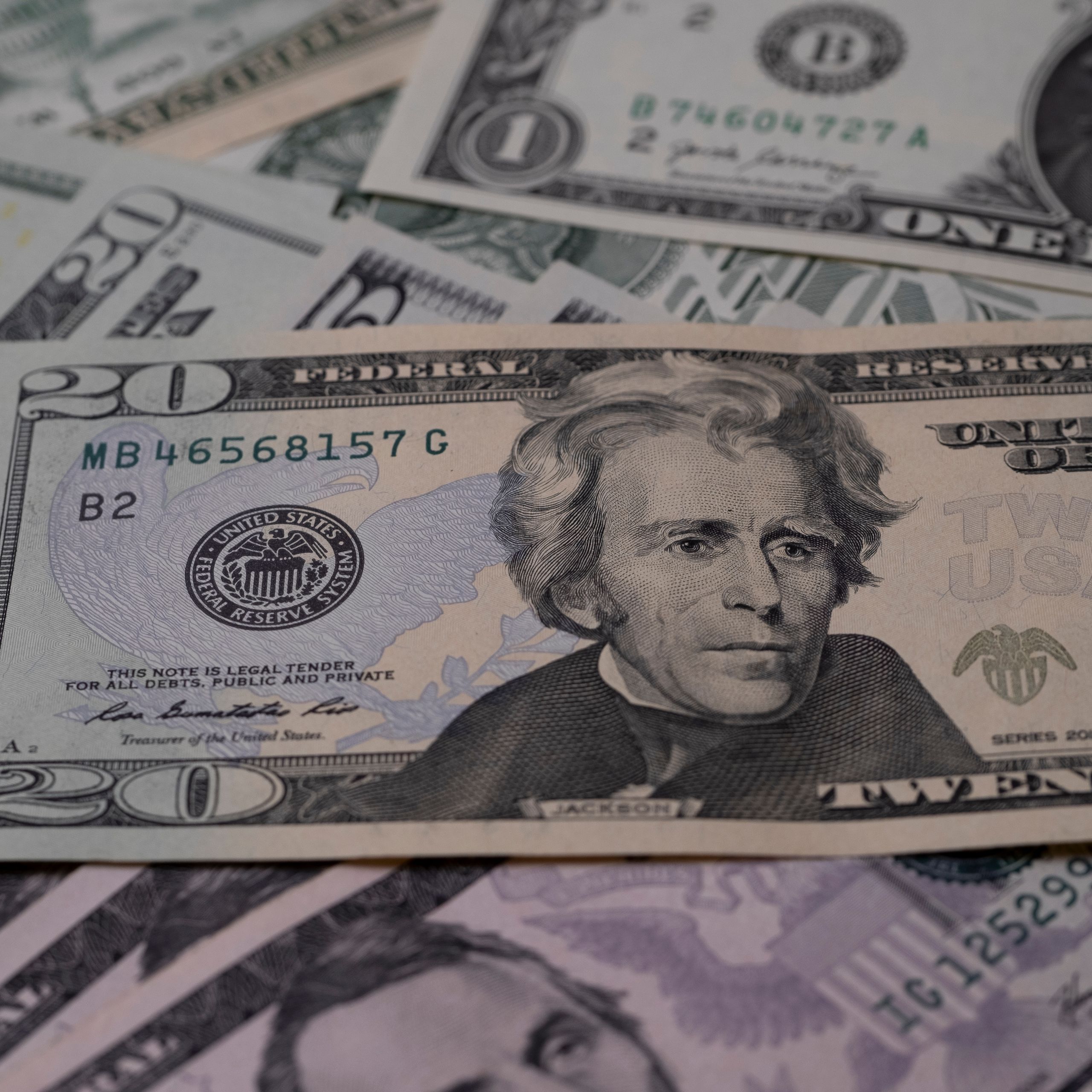 Detailed image of US dollar bills showcasing various denominations symbolizing finance and wealth.