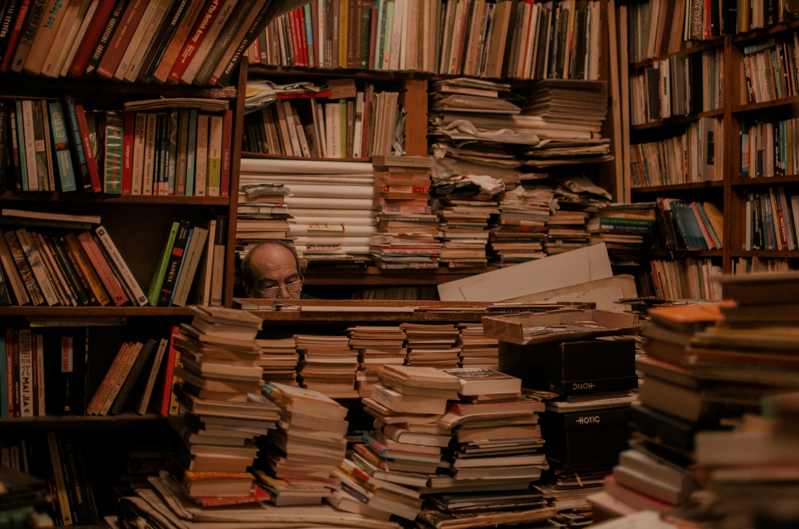Explore a cluttered bookstore full of stacked books and hidden wisdom.