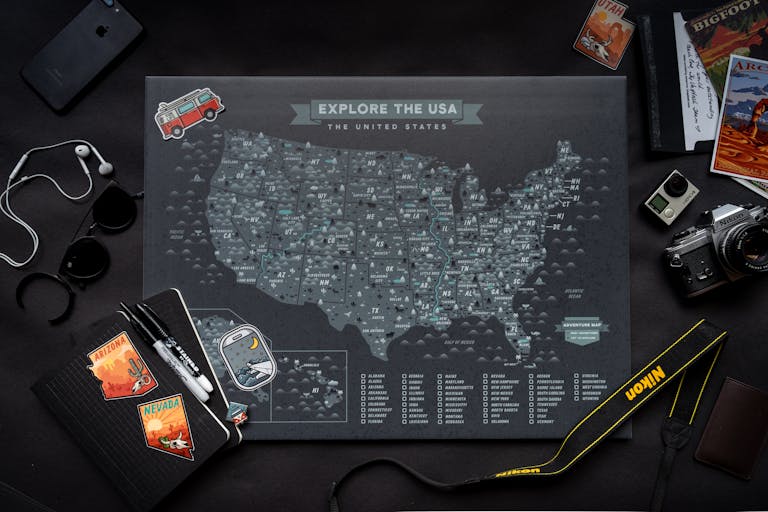 Explore USA map with travel gear in a flat lay arrangement, perfect for planning adventures.