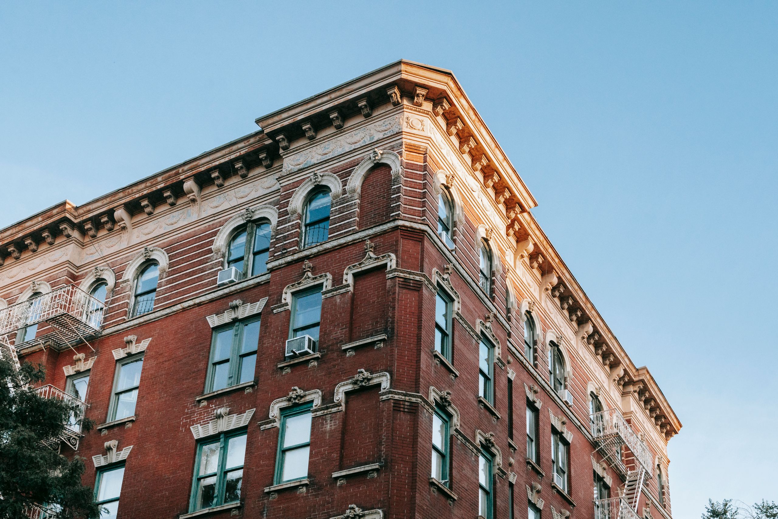 Low angle of aged masonry building on background of blue cloudless sky in soft daylight