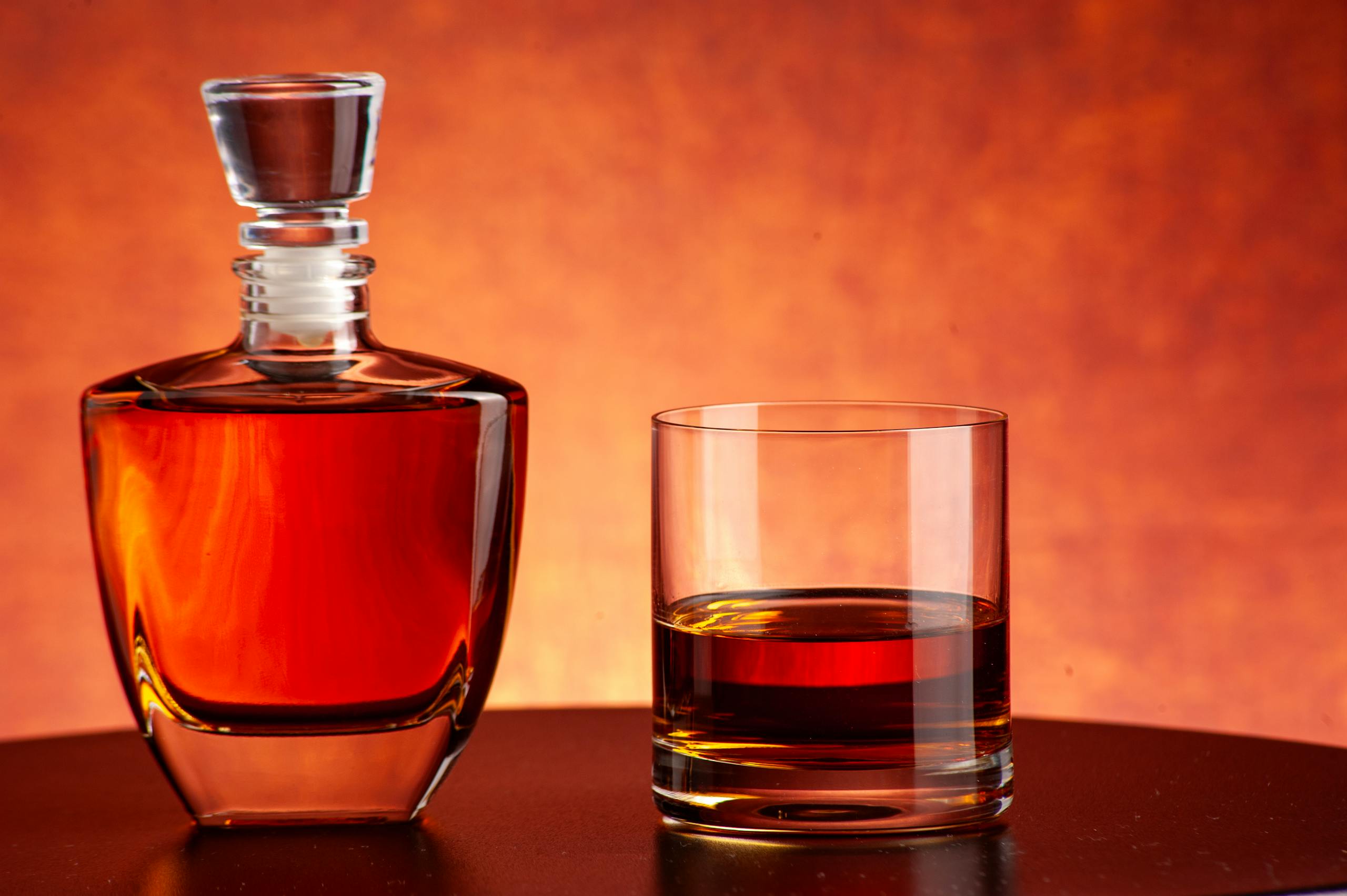 Luxurious whiskey decanter and glass set against a warm, inviting backdrop. Perfect for bars and homes.