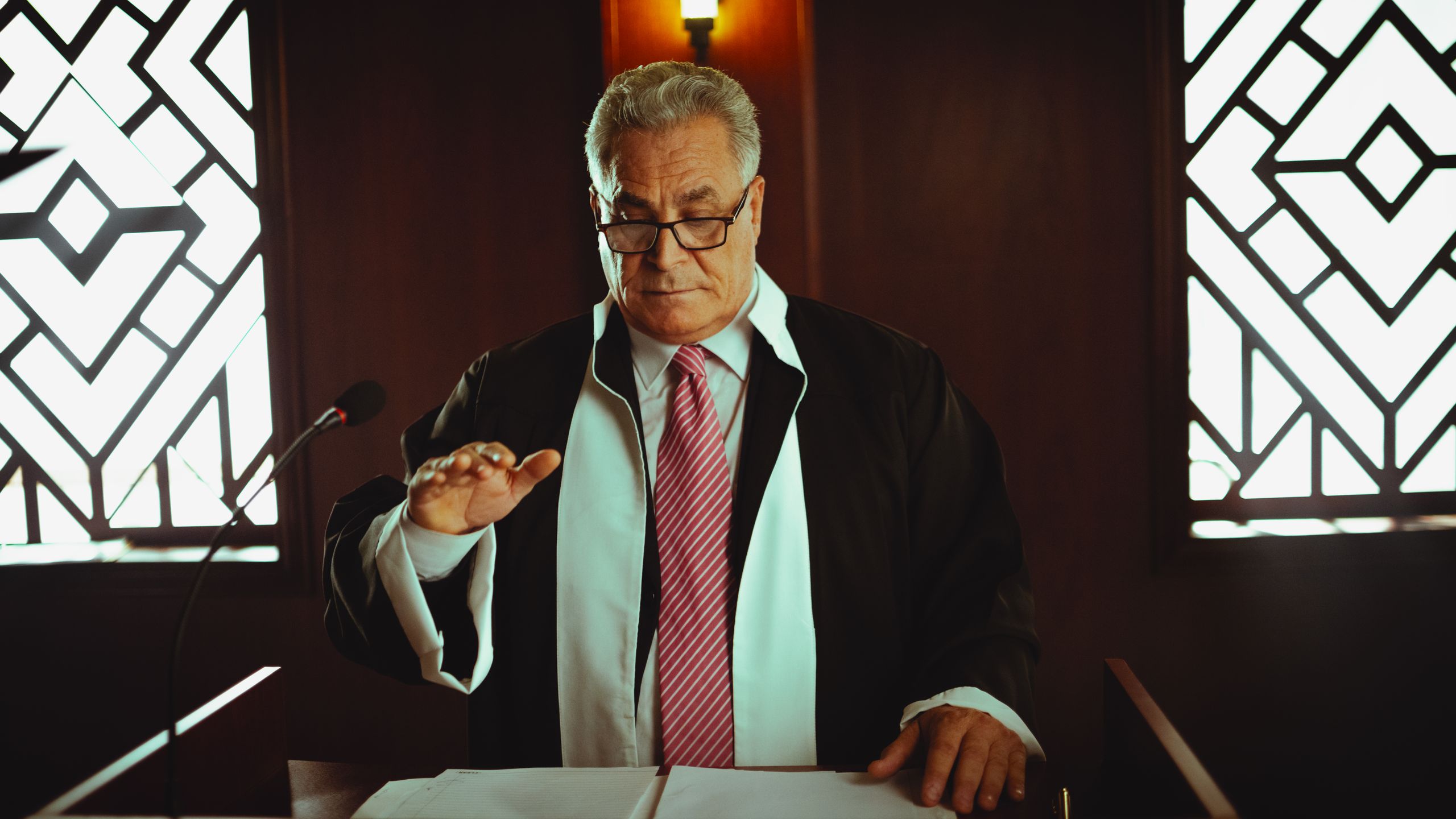 Mature male judge in a courtroom taking an oath, Baghdad, Iraq.
