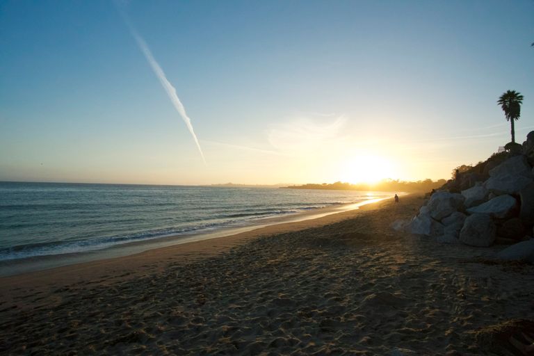 Peaceful beach at sunset in Santa Cruz, California, with tranquil waves and golden light.
