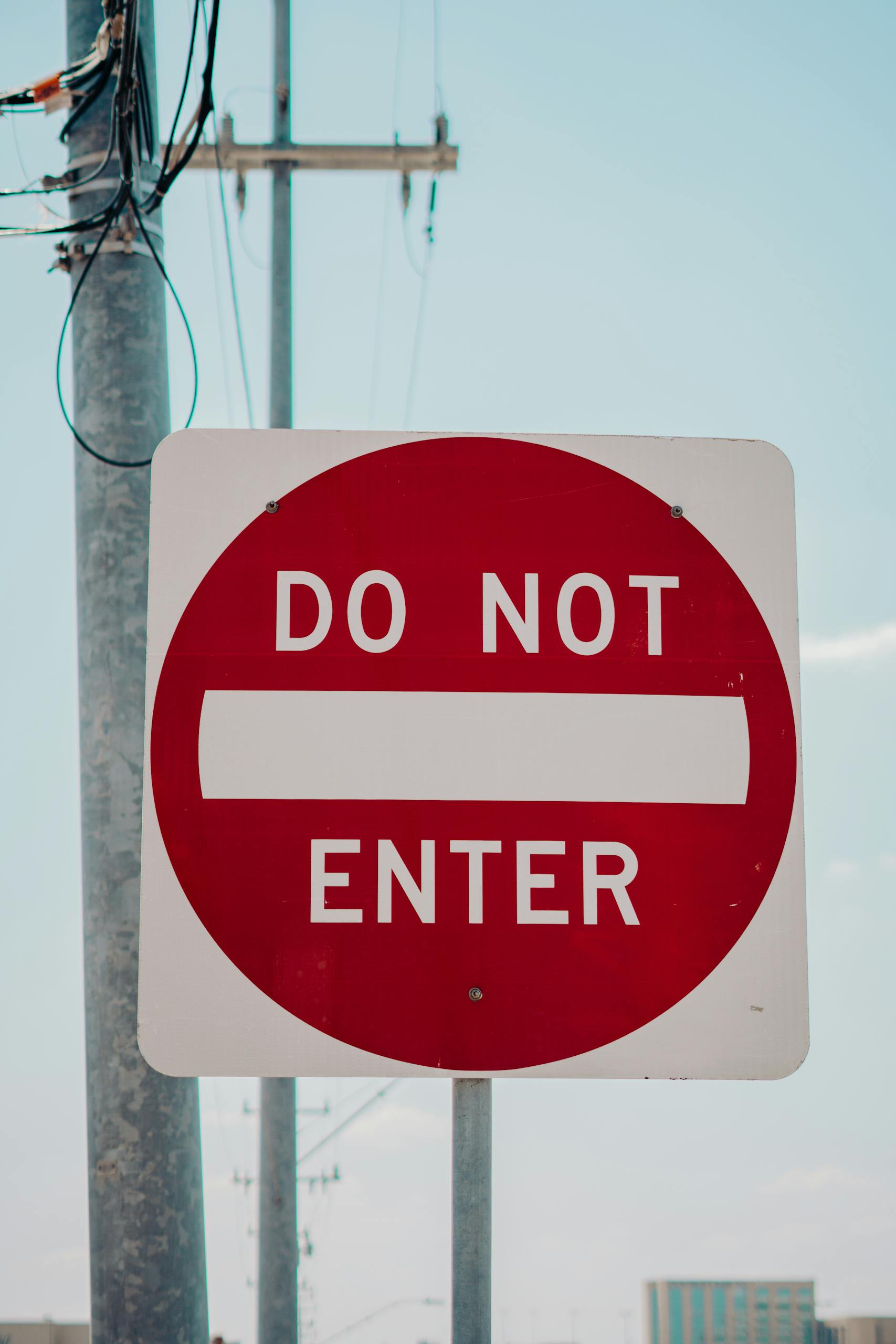 Red 'Do Not Enter' sign on a street in San Antonio, TX, USA.