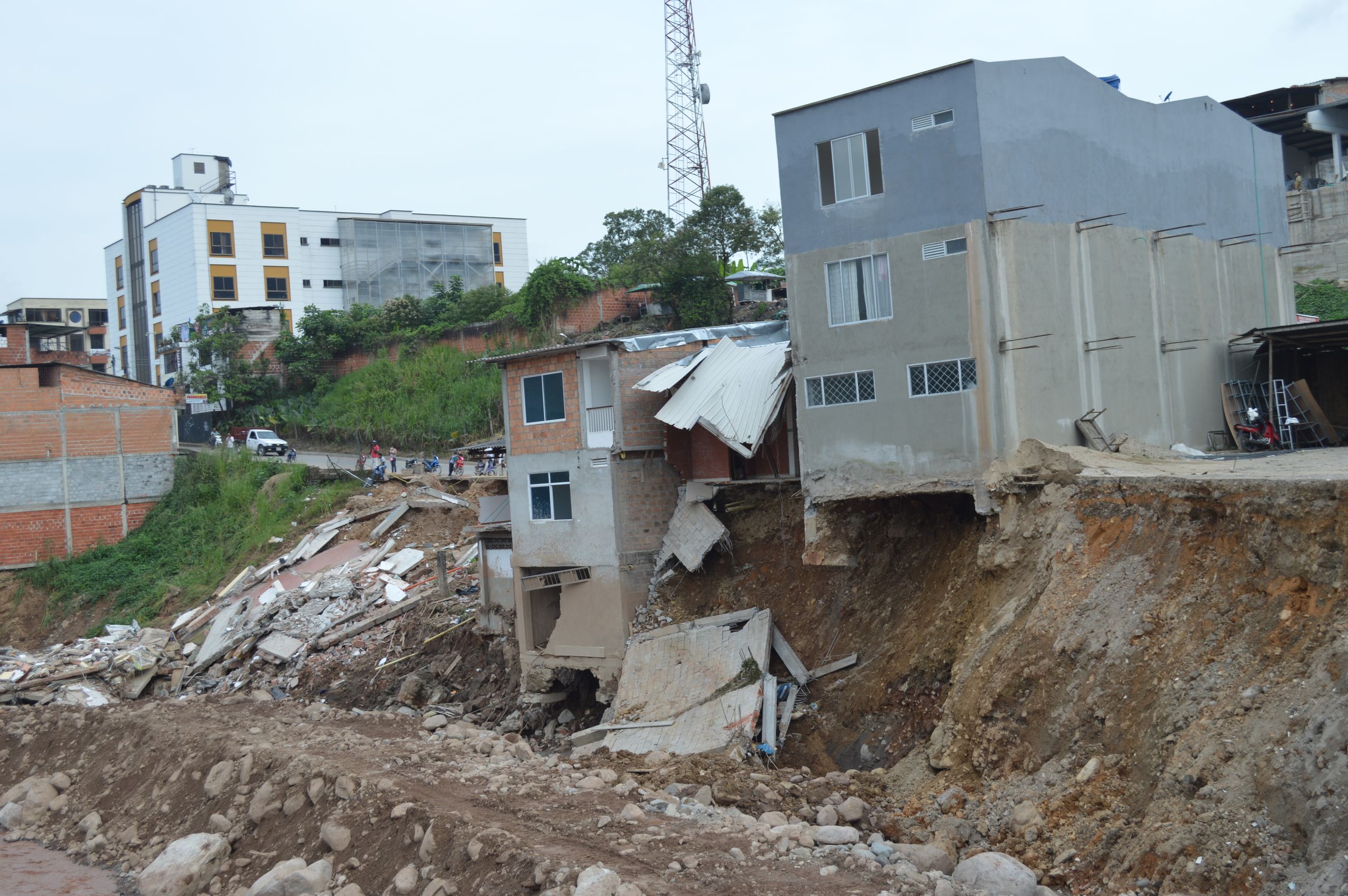 Severely damaged urban buildings after a landslide in Mocoa, Colombia, showcasing destruction.