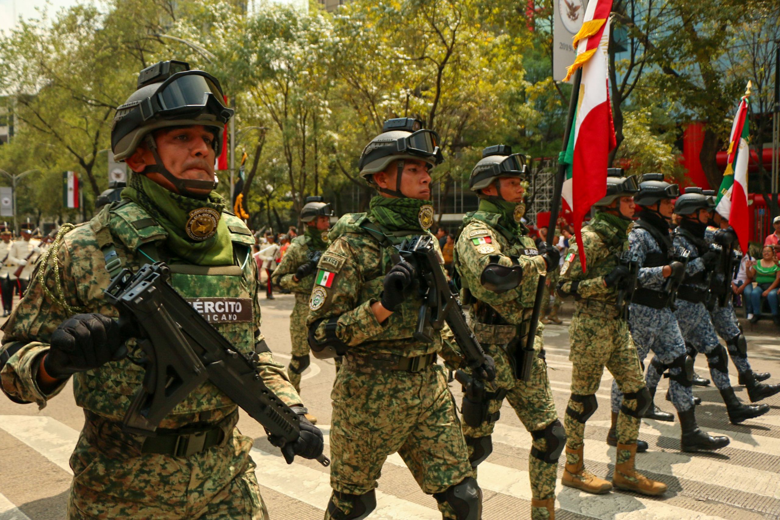 Soldiers from the Mexican army marching in uniform during a public parade, displaying national pride.