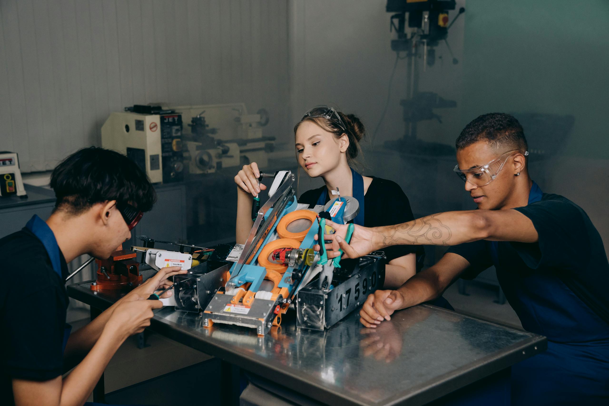 Students engaged in assembling a robotics project in an educational lab setting.