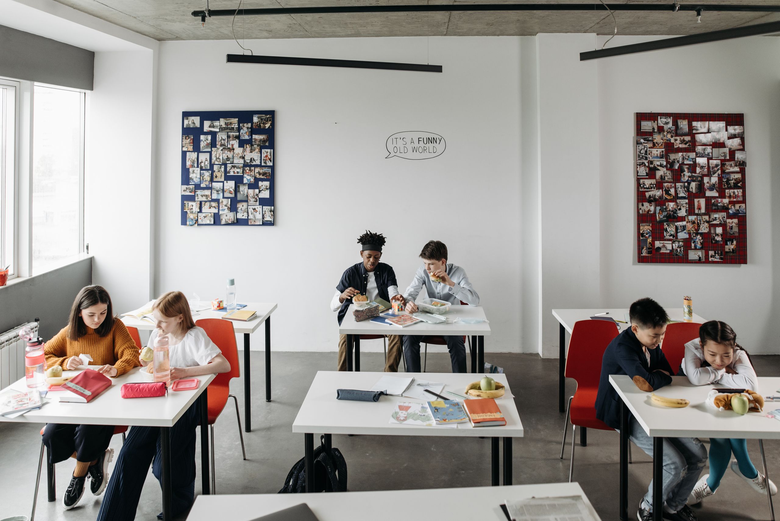 Students enjoy a light-hearted break in a modern classroom setting, fostering diversity and interaction.
