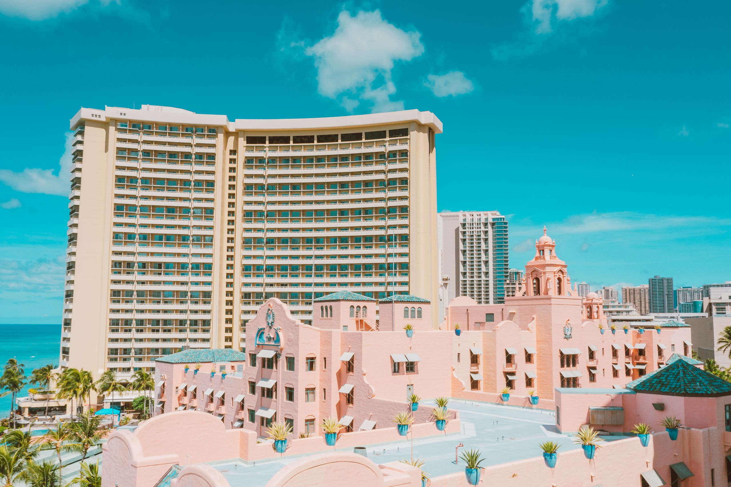 Stunning view of modernist hotel buildings under a vibrant blue sky near the ocean in sunny weather.