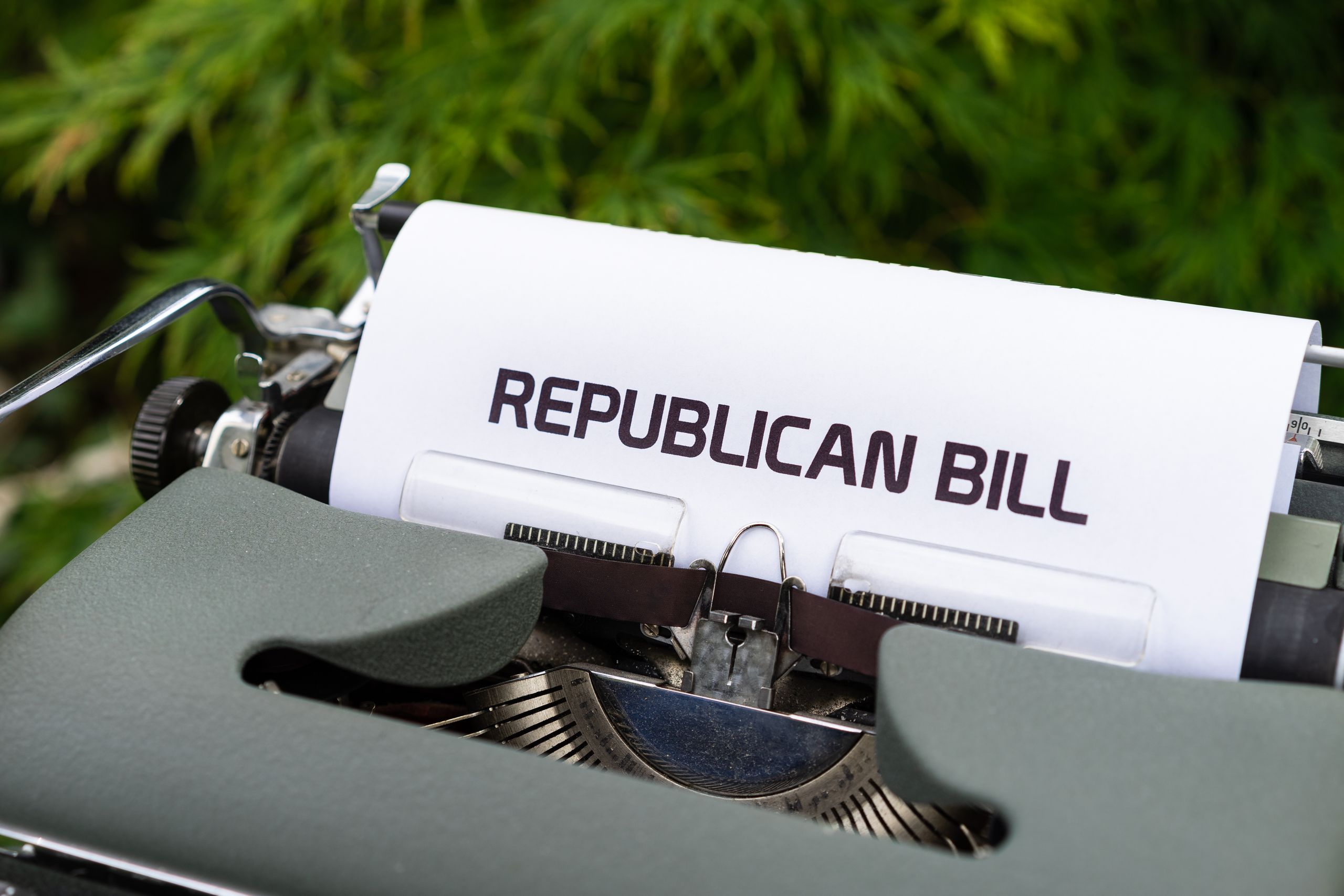 Typewriter displaying 'Republican Bill' in an outdoor setting.