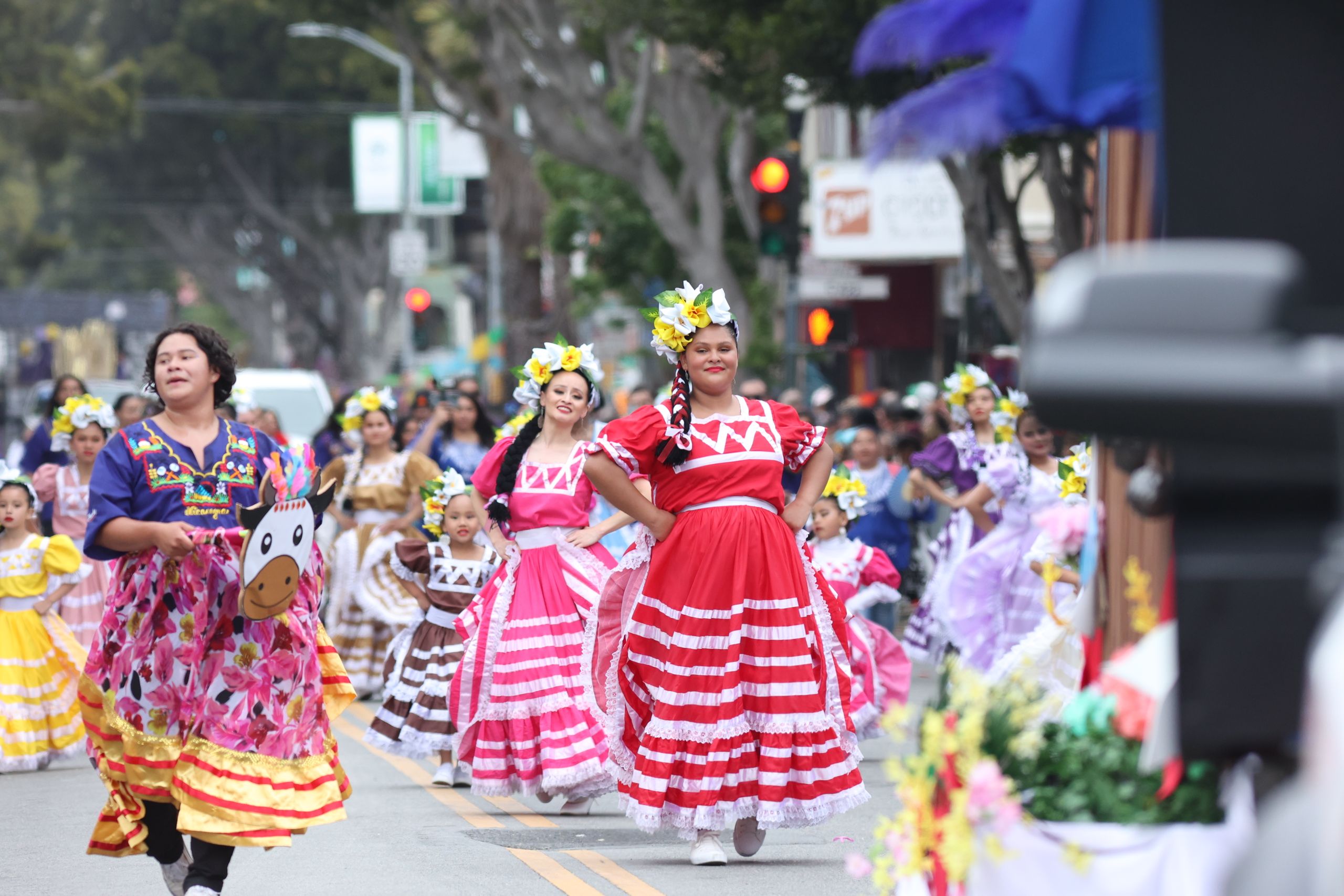Vibrant cultural festival with traditional dancers parading in colorful costumes in San Francisco.