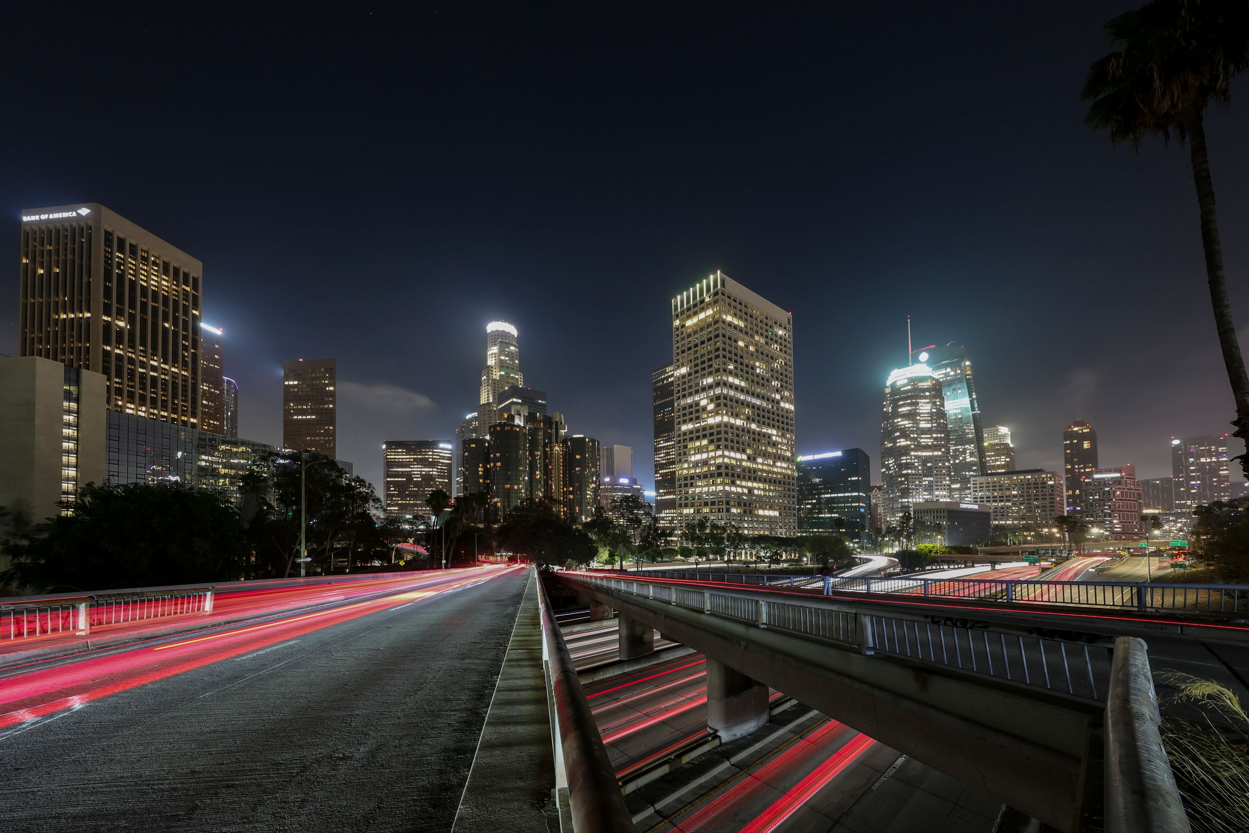 Vibrant long exposure of Downtown Los Angeles skyscrapers at night, showcasing the city skyline.