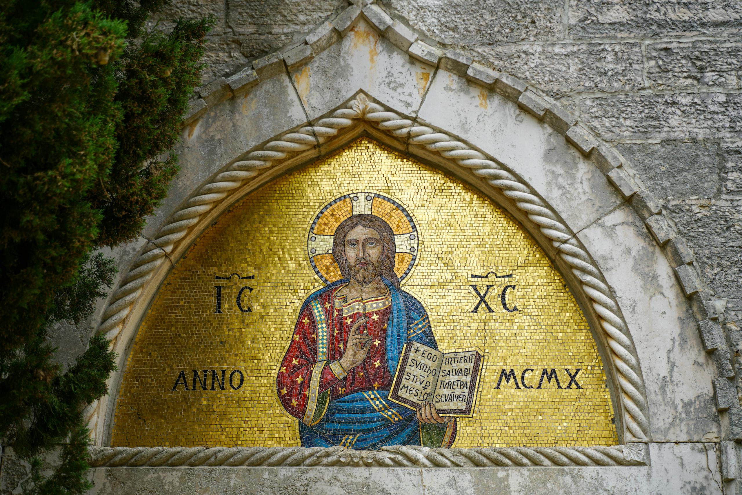 Vibrant mosaic of Christ on a church wall in Istria, Croatia, depicting religious art.