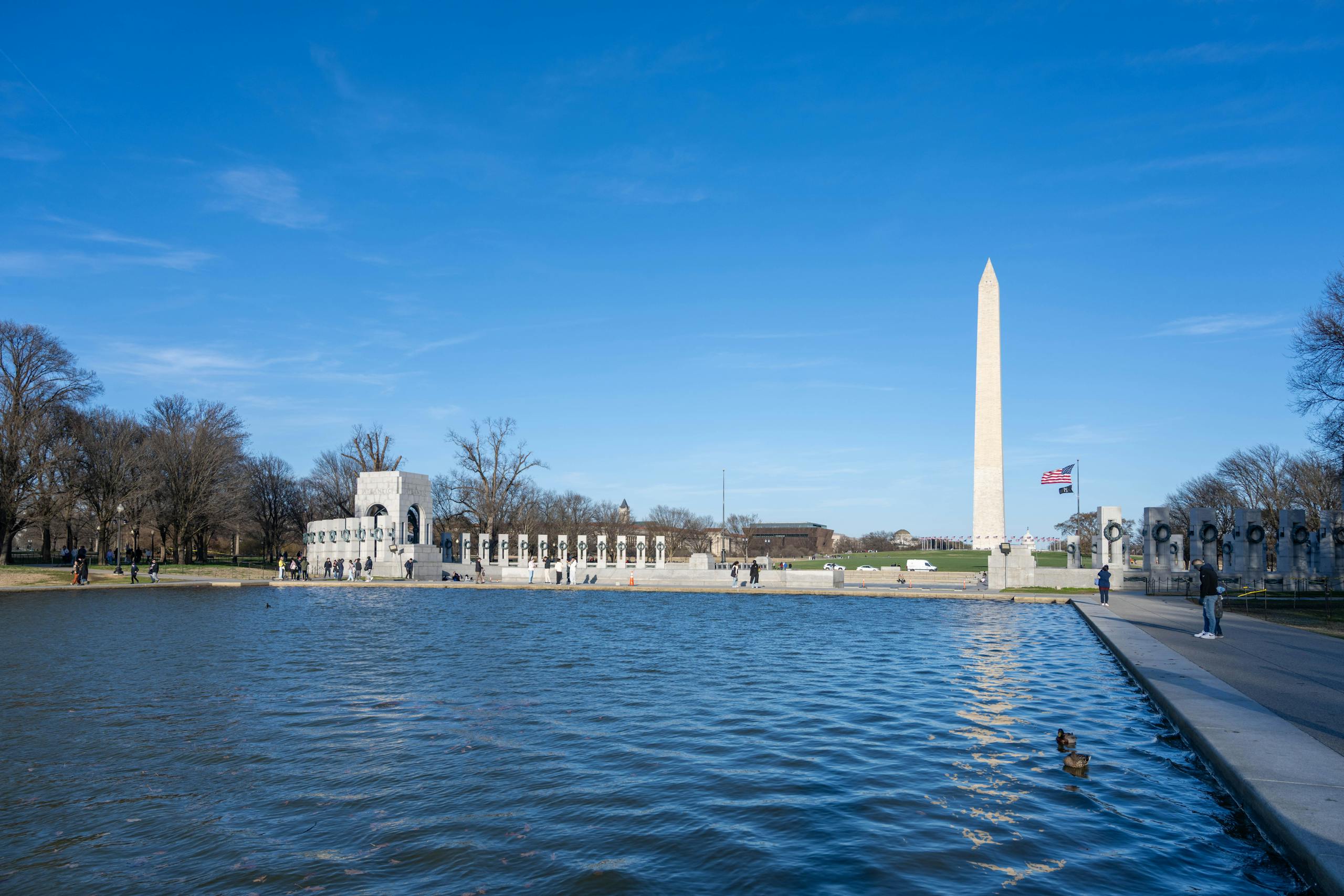 View of the Washington Monument with clear skies and the reflecting pool in Washington, D.C.