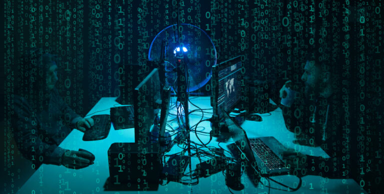 Wanted hackers coding virus ransomware using laptops and computers. Cyber attack, system breaking and malware concept.