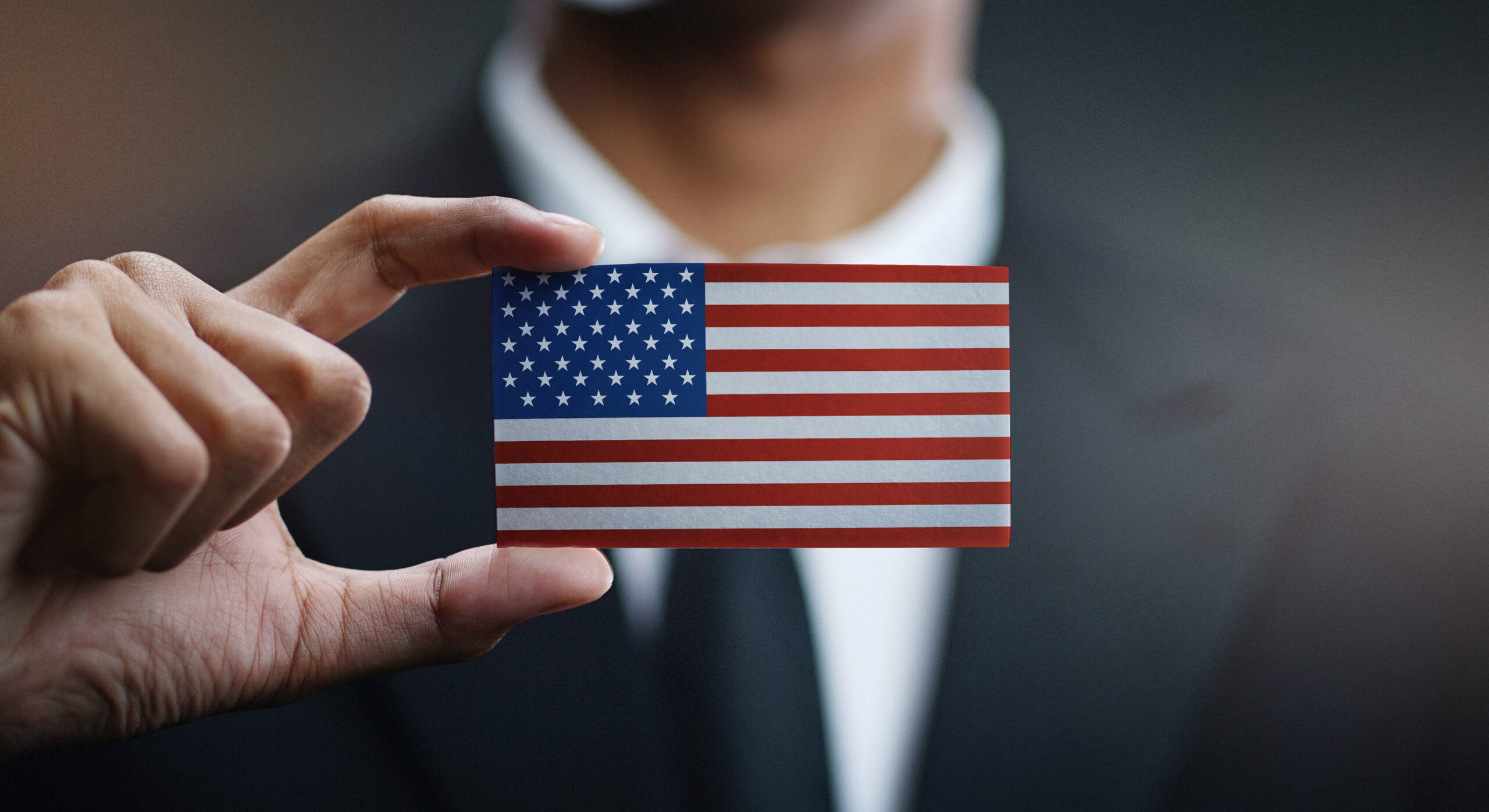 Businessman Holding Card of United States of America Flag