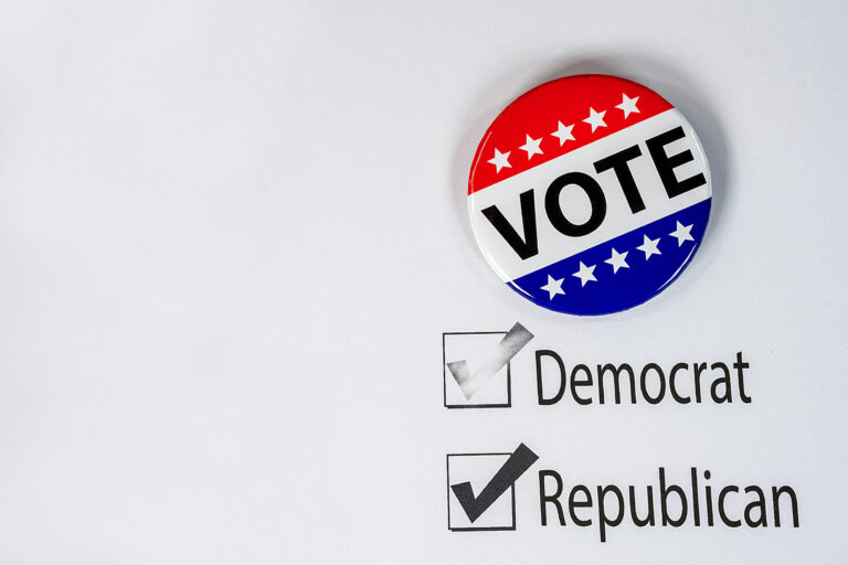 patriotic vote pin on election ballot with check mark on political party choice