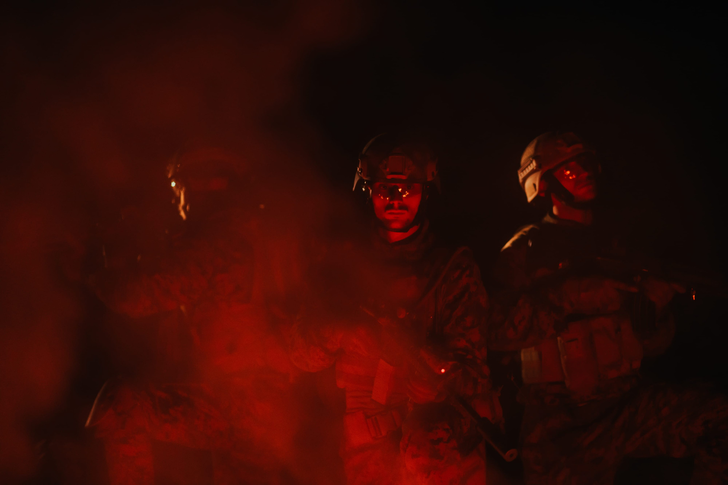 Soldiers squad in action on night mission using laser sight beam lights military team concept