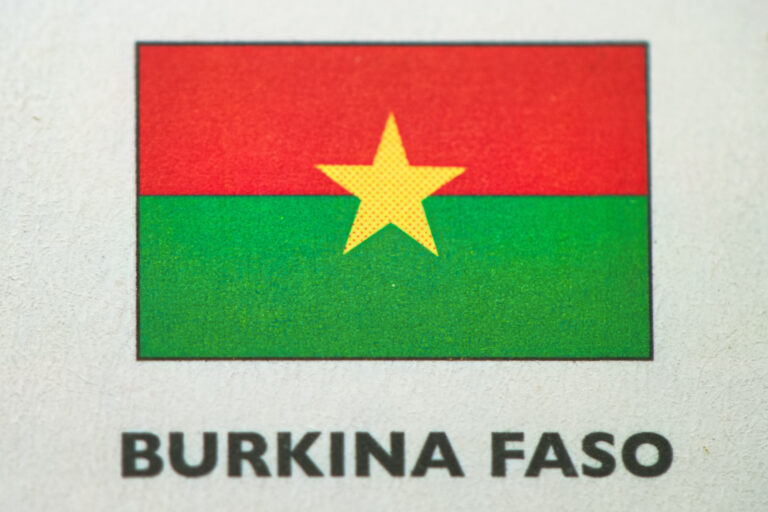 Burkina Faso flag printed on paper close-up.