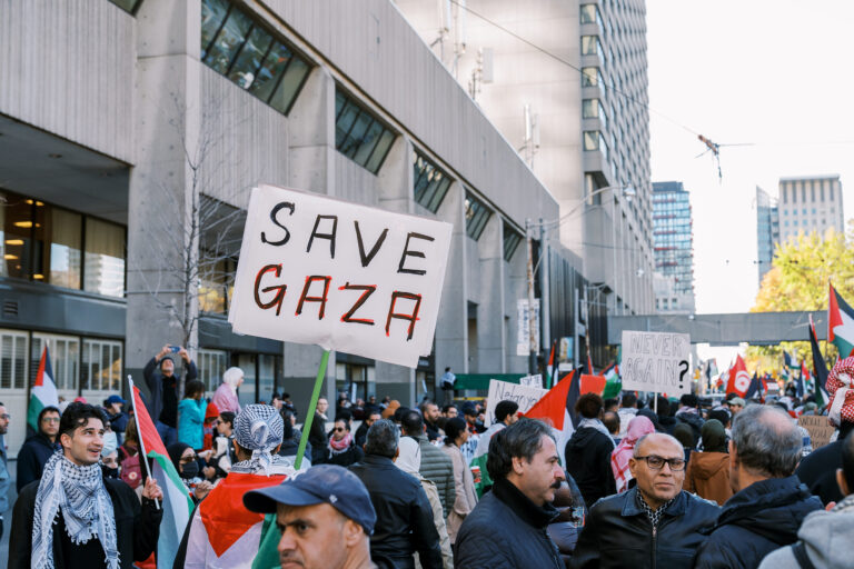 Toronto, Canada - 28 October 2023: Anti-war march in Toronto by Palestinians against Israels aggression in Gaza. Citys peaceful protest against Israel-HAMAS war. Protesters wave flags