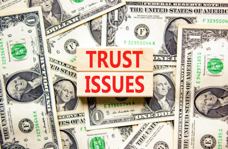 Trust issues symbol. Concept word Trust issues on beautiful wooden blocks. Dollar bills. Beautiful dollar bills background. Business trust issues concept. Copy space.