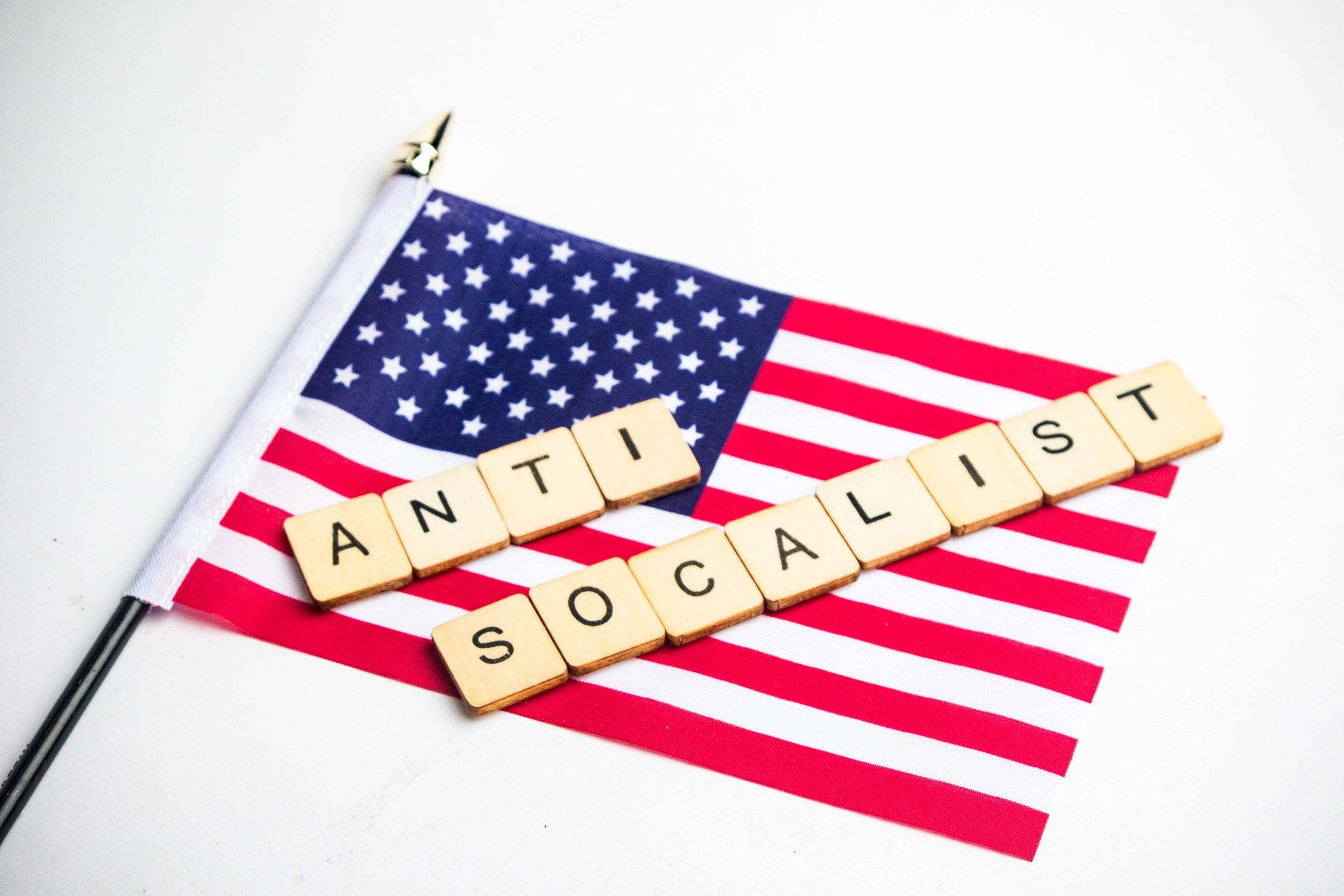 A View Of The American Flag With Anti Socalist Spelt Across It, On A White Background
