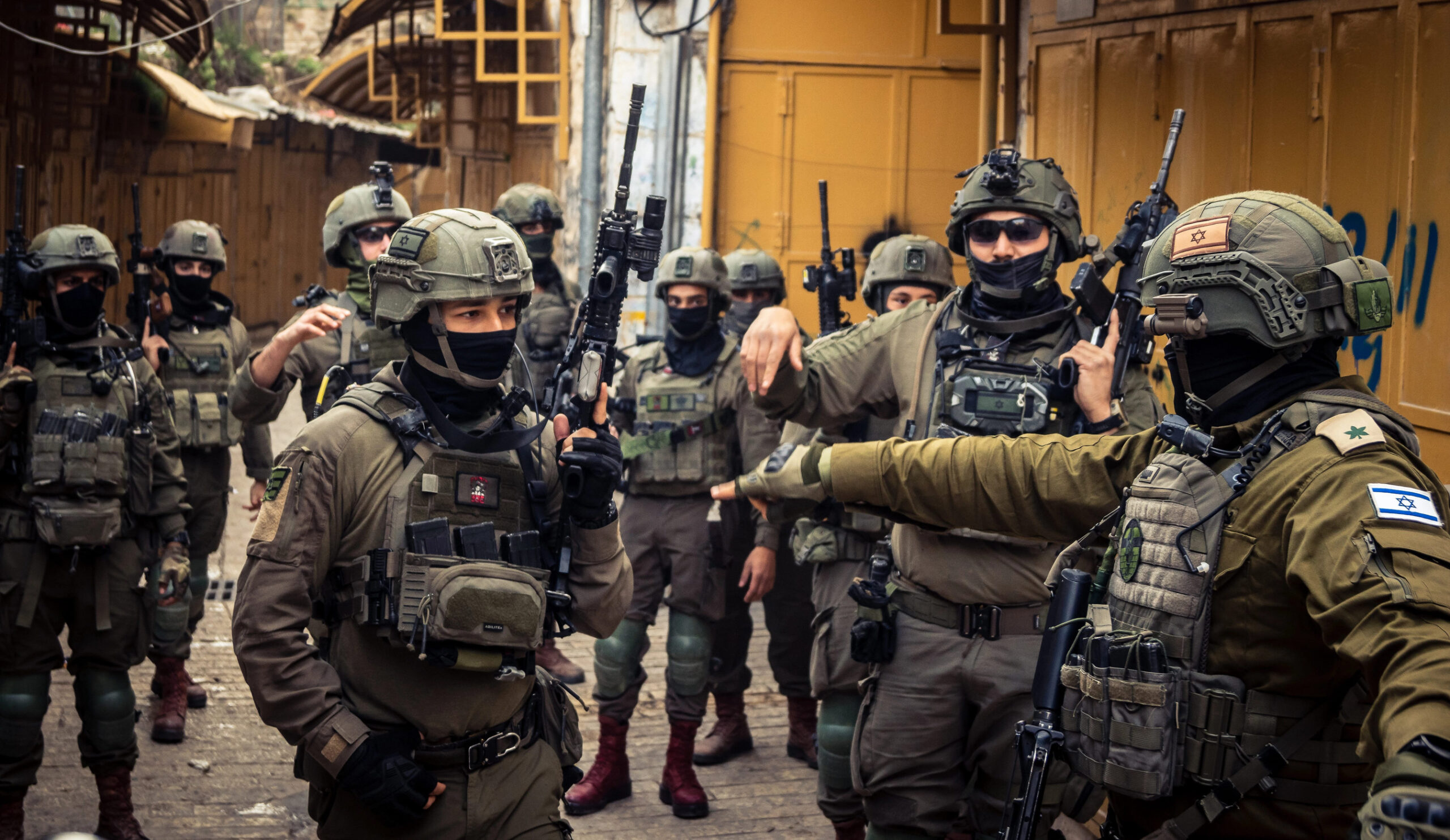 Hebron, West Bank, Palestine. February 14, 2026 Israeli soldiers (IDF) securing and protecting settlers in the old city of Hebron. Defense mission in a sensitive urban area.