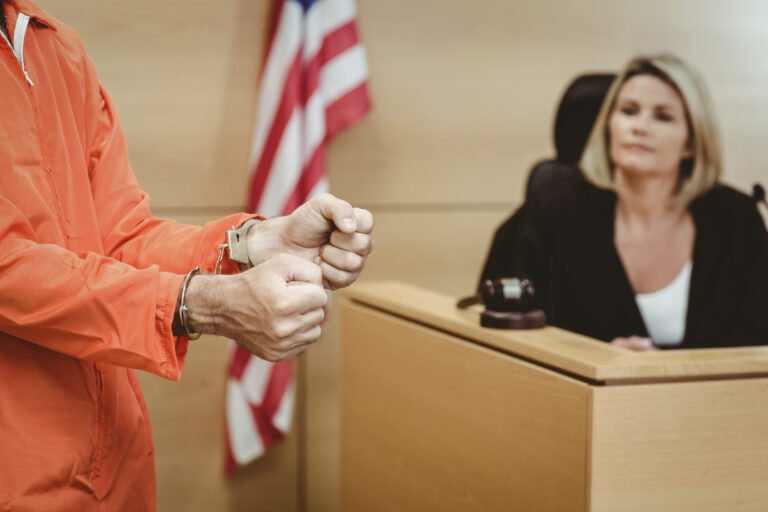 Close up of a prisoner wearing handcuffs in the court room