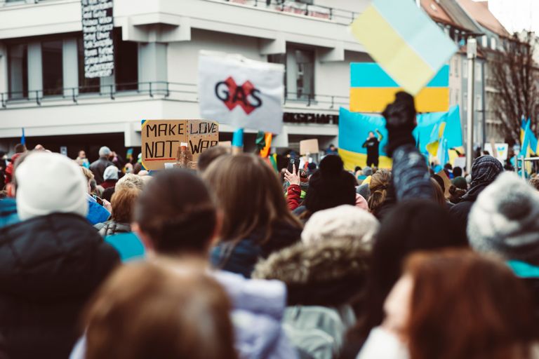 A vibrant protest with Ukraine flags, focusing on peace advocacy in an urban setting.